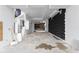 Unfinished interior space showcasing modern design with concrete floors and a unique black accent wall at 5210 Brownlee Rd, Stone Mountain, GA 30087