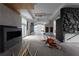 Open-concept unfinished living space showing design with statement fireplace and expansive windows at 5210 Brownlee Rd, Stone Mountain, GA 30087