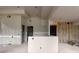 Open living room area with drywall, ready for finishes, and a breakfast bar at 5210 Brownlee Rd, Stone Mountain, GA 30087