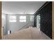 Spacious loft featuring unique accent wall, large windows, and staircase at 5210 Brownlee Rd, Stone Mountain, GA 30087