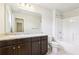 Bathroom featuring a granite countertop, bathtub, toilet, and modern fixtures at 72 Fern Walk, Lawrenceville, GA 30045