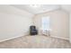 Cozy bedroom featuring neutral paint, plush carpet, and plenty of natural light at 72 Fern Walk, Lawrenceville, GA 30045