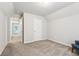Bright bedroom with plush carpet, neutral paint, and access to a hallway at 72 Fern Walk, Lawrenceville, GA 30045
