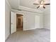 Bright bedroom featuring plush carpet, tray ceiling, and door to a closet at 72 Fern Walk, Lawrenceville, GA 30045