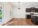 Cozy dining area with contemporary chandelier, hardwood floors, and easy access to the kitchen at 72 Fern Walk, Lawrenceville, GA 30045