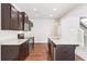 Stylish kitchen with granite counters, stainless appliances, and dark cabinetry, open to living area at 72 Fern Walk, Lawrenceville, GA 30045