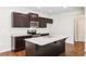 Modern kitchen featuring granite countertops, stainless steel appliances, and dark wood cabinetry at 72 Fern Walk, Lawrenceville, GA 30045