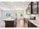 Well-equipped kitchen with an island, modern appliances, granite counters and hardwood flooring at 72 Fern Walk, Lawrenceville, GA 30045