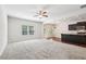 Bright living area showcasing neutral carpeting, large windows, and views into the modern eat-in kitchen at 72 Fern Walk, Lawrenceville, GA 30045