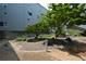 A landscaped courtyard featuring gravel, greenery, trees, benches, and a well-maintained exterior at 850 Ralph Mcgill Ne Blvd # 6, Atlanta, GA 30306