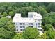 A modern apartment building surrounded by mature trees, showcasing its architectural design and natural setting at 850 Ralph Mcgill Ne Blvd # 6, Atlanta, GA 30306