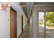 Hallway with modern concrete ceiling, visible ductwork, and a view of outdoor greenery at 850 Ralph Mcgill Ne Blvd # 6, Atlanta, GA 30306