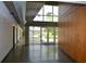 Long hallway with modern concrete ceiling, ductwork, and double glass door exiting to greenery at 850 Ralph Mcgill Ne Blvd # 6, Atlanta, GA 30306