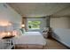 Cozy bedroom featuring carpet floors, a large bed with a tufted headboard and ambient lighting at 850 Ralph Mcgill Ne Blvd # 6, Atlanta, GA 30306