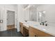 Bathroom showcasing double vanity, modern lighting, and a glass-enclosed shower for a spa-like experience at 1659 Tielman Way, Snellville, GA 30078