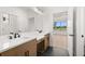 Modern bathroom with double sink vanity, wood cabinets, and tiled floors at 1659 Tielman Way, Snellville, GA 30078