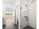 Stylish bathroom with a glass shower and dark floor tiles, offering a sleek and modern design at 1659 Tielman Way, Snellville, GA 30078