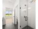 Sleek bathroom with glass-enclosed shower and black fixtures at 1659 Tielman Way, Snellville, GA 30078