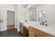 Bathroom featuring double sinks, wood cabinets, and black hardware at 1659 Tielman Way, Snellville, GA 30078