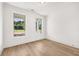 Bright bedroom features wood-look floors, fresh white paint, and two windows overlooking the yard at 1659 Tielman Way, Snellville, GA 30078