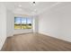 Well-lit bedroom with ample space, large windows and light hardwood flooring at 1659 Tielman Way, Snellville, GA 30078