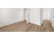 Spacious bedroom with neutral walls and hardwood floors, adjacent to a walk-in closet at 1659 Tielman Way, Snellville, GA 30078