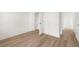 Bedroom with hardwood floors, white trim, and several doorways at 1659 Tielman Way, Snellville, GA 30078