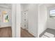 Bright entryway featuring wood floors, white walls, with a view through to the front door at 1659 Tielman Way, Snellville, GA 30078