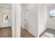 Modern entry showcasing hardwood floors, white walls, and a hallway leading to the front door at 1659 Tielman Way, Snellville, GA 30078