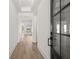 Elegant entryway features light wood floors, crisp white walls, and glass paneled front door at 1659 Tielman Way, Snellville, GA 30078