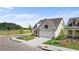 New construction home with a side entry two car garage, a sidewalk, and manicured landscaping at 1659 Tielman Way, Snellville, GA 30078
