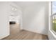 Hallway with wood flooring and white walls leading to modern kitchen at 1659 Tielman Way, Snellville, GA 30078