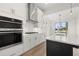 Modern kitchen featuring stainless steel appliances, white cabinetry, and a central island at 1659 Tielman Way, Snellville, GA 30078