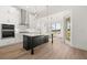 Modern kitchen featuring white cabinets, stainless steel appliances, island with quartz countertop, and wood flooring at 1659 Tielman Way, Snellville, GA 30078