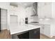 An open kitchen with white cabinets, quartz countertops, stainless steel appliances, and an island at 1659 Tielman Way, Snellville, GA 30078