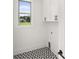 Functional laundry room with stylish geometric tile floor and storage cabinets at 1659 Tielman Way, Snellville, GA 30078