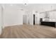 Open-concept living room and kitchen featuring modern design and wood flooring at 1659 Tielman Way, Snellville, GA 30078