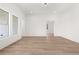 Spacious living room with wood flooring, neutral walls, and large windows at 1659 Tielman Way, Snellville, GA 30078