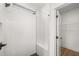 Contemporary shower stall featuring sleek white tiles, black hardware, and a convenient corner seat at 1659 Tielman Way, Snellville, GA 30078