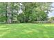 Expansive backyard with mature trees and playground equipment at 1744 Chateau Dr, Dunwoody, GA 30338