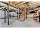 Unfinished basement with exposed beams and stairs at 1744 Chateau Dr, Dunwoody, GA 30338