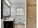 Bathroom featuring a dark vanity, granite countertop, tiled backsplash, tiled shower and toilet at 1744 Chateau Dr, Dunwoody, GA 30338