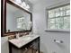 Bathroom featuring a dark vanity, granite countertop, tiled backsplash, and a framed mirror at 1744 Chateau Dr, Dunwoody, GA 30338