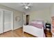 Cozy bedroom with hardwood floors, closet, decorative mirror and neutral paint at 1744 Chateau Dr, Dunwoody, GA 30338
