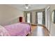 Bedroom with hardwood floors, ceiling fan, closet and bright, sunlit windows at 1744 Chateau Dr, Dunwoody, GA 30338