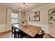 Stylish dining room features a wooden table, modern light fixture, and decorative shelving at 1744 Chateau Dr, Dunwoody, GA 30338