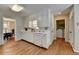 Well-lit kitchen with white cabinets, hardwood floors and adjacent dining and laundry areas at 1744 Chateau Dr, Dunwoody, GA 30338