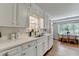 Traditional white kitchen, well-lit, with breakfast area and stainless steel sink at 1744 Chateau Dr, Dunwoody, GA 30338