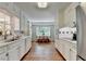 Charming kitchen featuring white cabinetry, a stainless steel sink, and an adjacent breakfast nook with lots of windows at 1744 Chateau Dr, Dunwoody, GA 30338