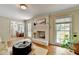 Sunlit living room with fireplace and open layout to the dining area at 1744 Chateau Dr, Dunwoody, GA 30338